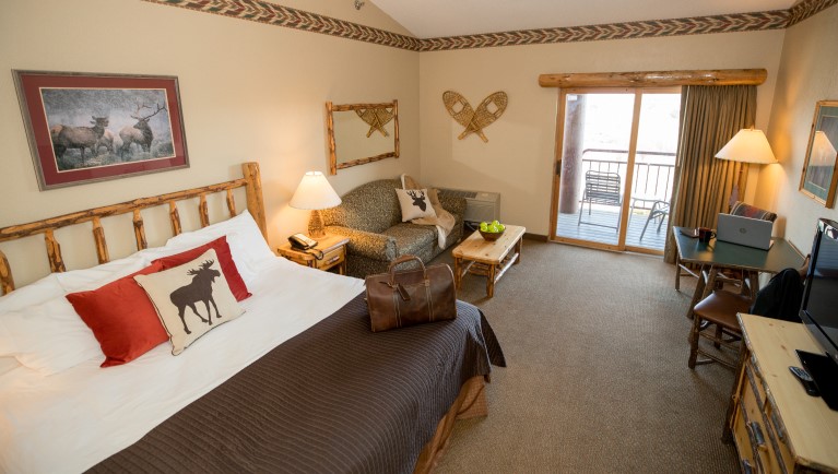 The bed in the Luxury King Suite (Accessible bathtub)